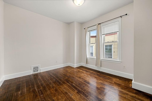 unfurnished room with dark hardwood / wood-style flooring