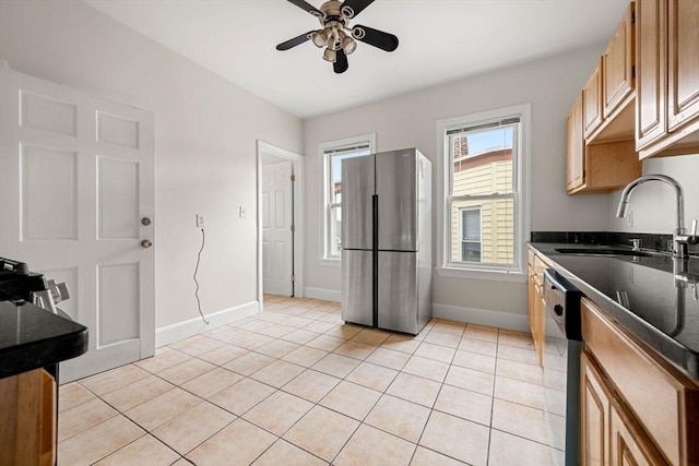 kitchen with ceiling fan, appliances with stainless steel finishes, sink, and light tile patterned floors