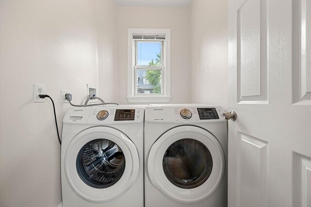 clothes washing area with washing machine and clothes dryer