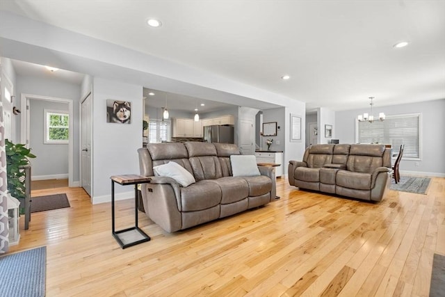 10 Brickett Ave, Haverhill, MA 01830 - living room featuring a chandelier, light wood-type flooring, baseboards, and recessed lighting