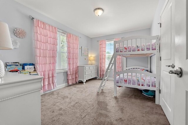 10 Brickett Ave, Haverhill, MA 01830 - bedroom with carpet floors, multiple windows, baseboards, and a nursery area