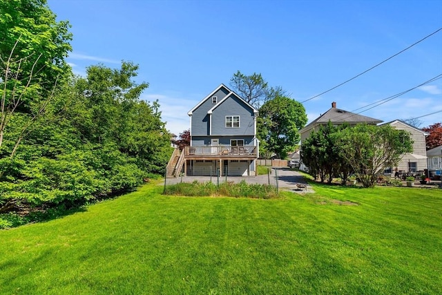 10 Brickett Ave, Haverhill, MA 01830 - rear view of property with a garage, a lawn, stairs, a wooden deck, and driveway