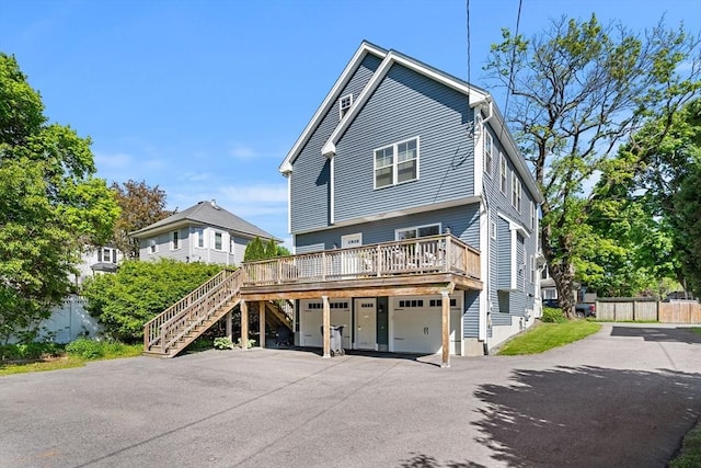 10 Brickett Ave, Haverhill, MA 01830 - view of front of property featuring asphalt driveway, stairway, an attached garage, a deck, and fence
