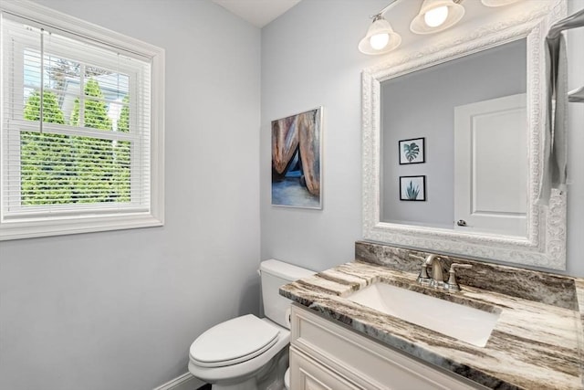 10 Brickett Ave, Haverhill, MA 01830 - bathroom featuring toilet, vanity, and baseboards