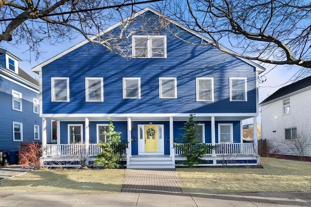 view of front of house featuring a porch and a front yard