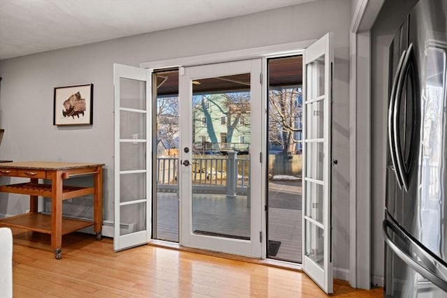 doorway to outside with french doors and light wood-style floors