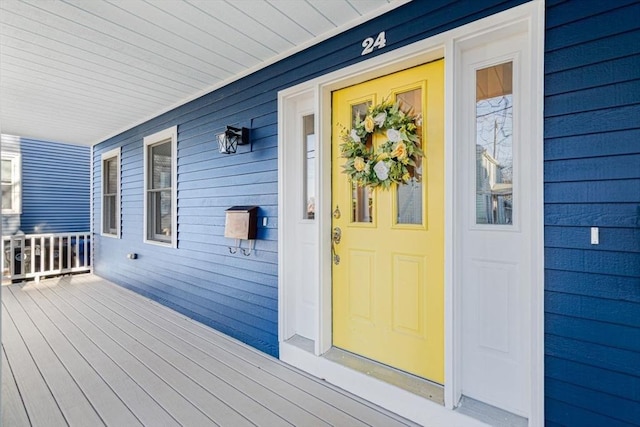 view of exterior entry with a porch