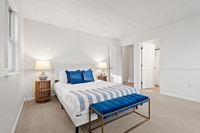 carpeted bedroom with baseboards