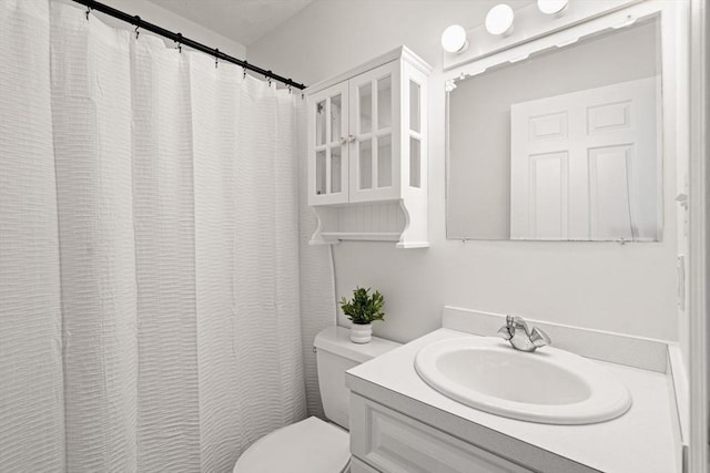 bathroom with toilet and vanity