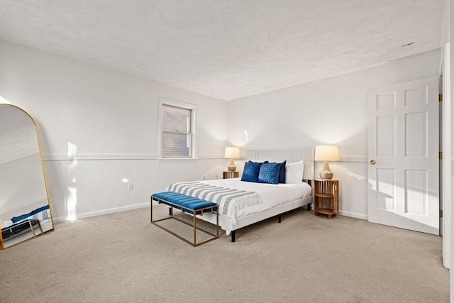 carpeted bedroom featuring baseboards and a textured ceiling