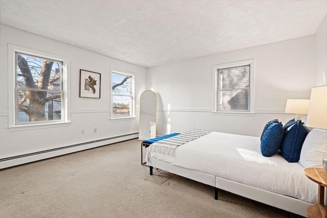 bedroom featuring a baseboard radiator, carpet floors, and a textured ceiling