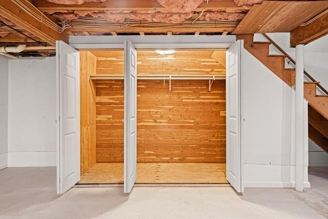 unfinished basement featuring stairs