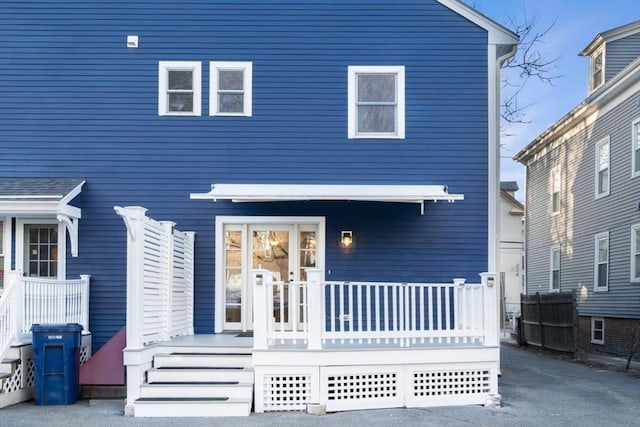 rear view of property with covered porch