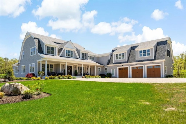 27 Gully Ln, Sandwich, MA 02537 - shingle-style home featuring a gambrel roof, an attached garage, covered porch, and a front yard