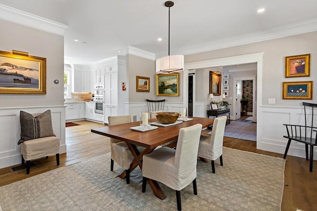 27 Gully Ln, Sandwich, MA 02537 - dining room with a decorative wall, light wood finished floors, crown molding, and recessed lighting