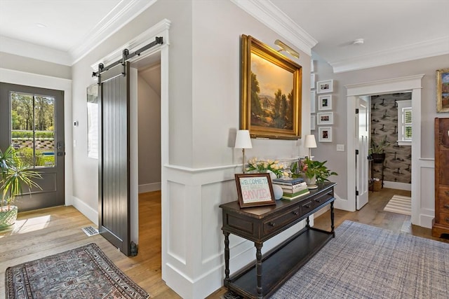 27 Gully Ln, Sandwich, MA 02537 - hallway featuring a barn door, light wood-type flooring, and ornamental molding