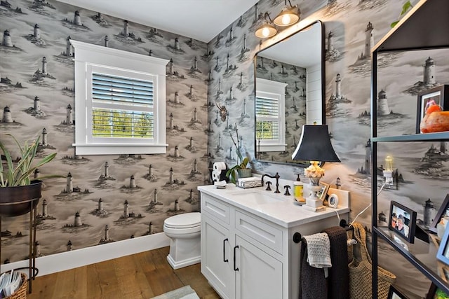 27 Gully Ln, Sandwich, MA 02537 - bathroom with hardwood / wood-style floors, wallpapered walls, and vanity