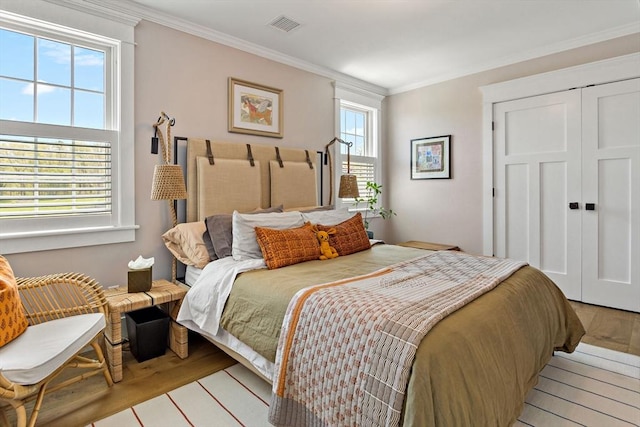 27 Gully Ln, Sandwich, MA 02537 - bedroom with light wood-style floors, crown molding, and a closet