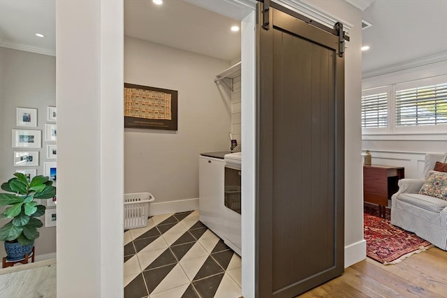 27 Gully Ln, Sandwich, MA 02537 - laundry area with washer / dryer, ornamental molding, a barn door, recessed lighting, and tile patterned floors