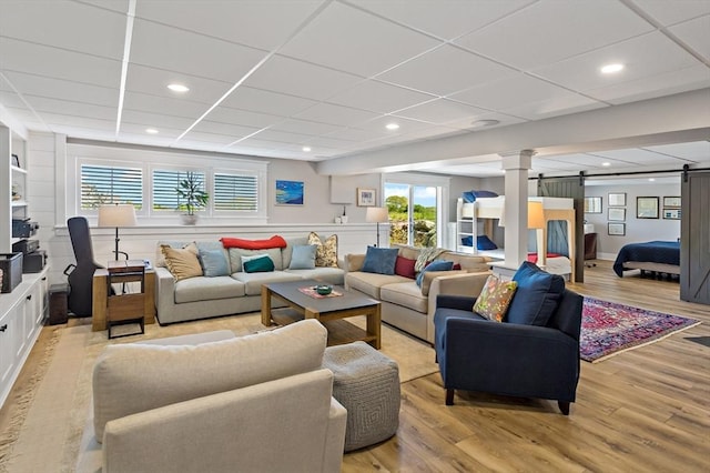 27 Gully Ln, Sandwich, MA 02537 - living area with a barn door, light wood-style floors, a drop ceiling, and recessed lighting