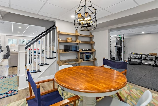 27 Gully Ln, Sandwich, MA 02537 - dining area featuring stairs, a drop ceiling, wood finished floors, a chandelier, and recessed lighting