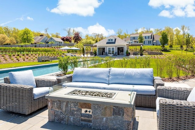 27 Gully Ln, Sandwich, MA 02537 - view of patio / terrace with an outdoor pool, an outbuilding, an outdoor living space with a fire pit, and a storage structure
