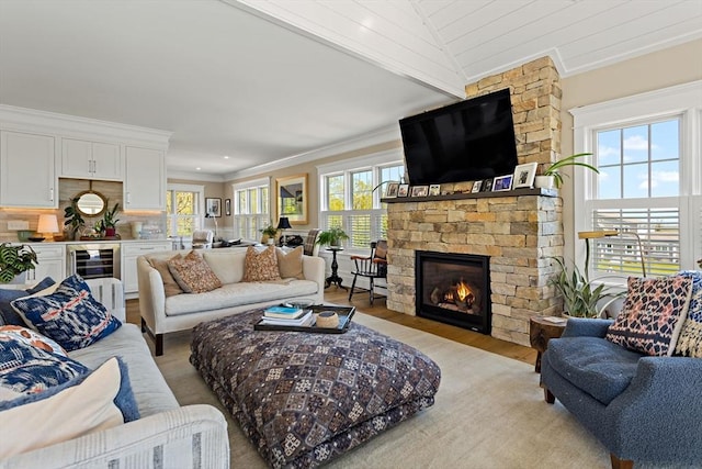 27 Gully Ln, Sandwich, MA 02537 - living area with light wood-style flooring, crown molding, a large fireplace, and wine cooler