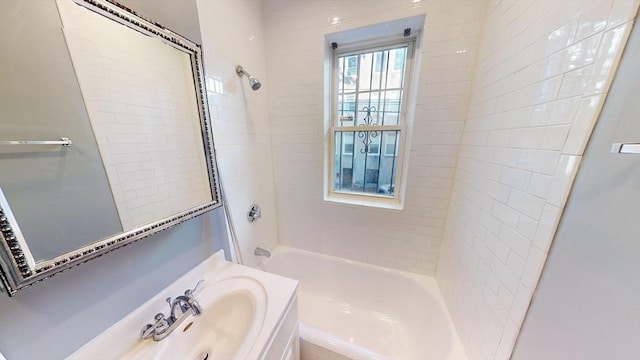 bathroom featuring vanity and tiled shower / bath combo