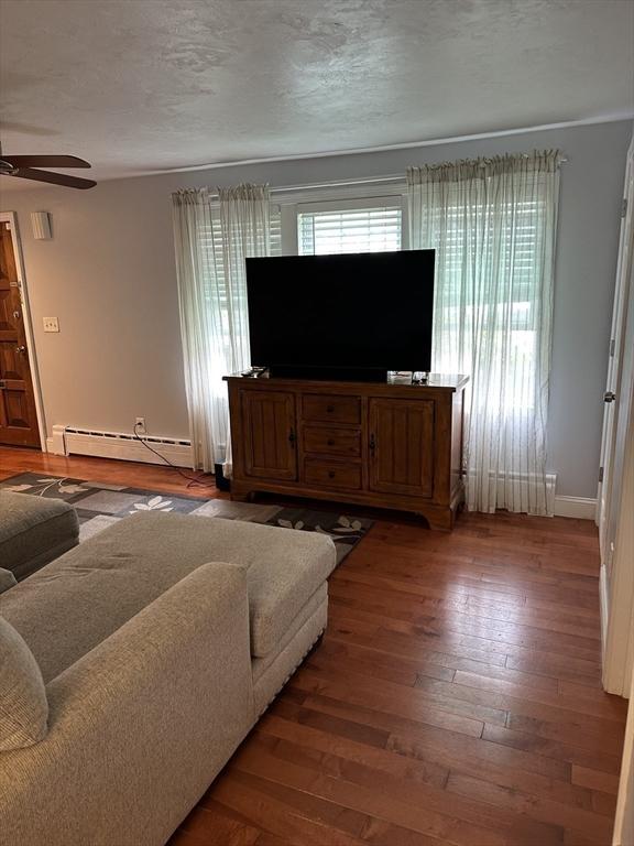 10 Marilyn Dr, Auburn, MA 01501 - living room with a baseboard radiator, a ceiling fan, and wood finished floors