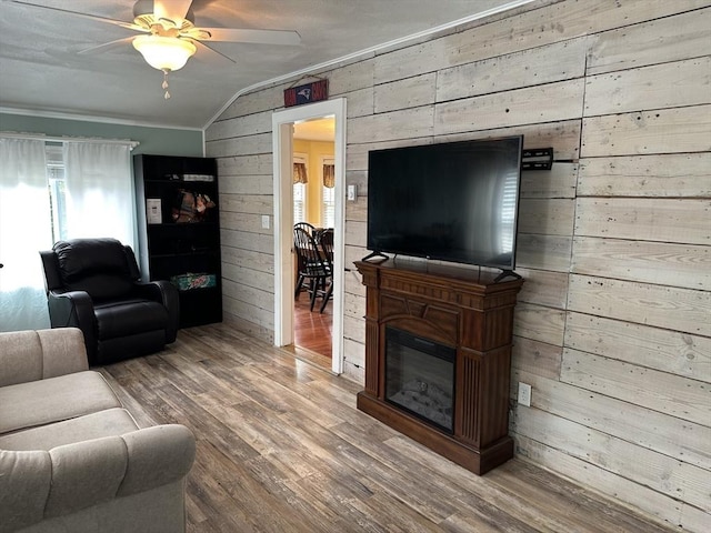 10 Marilyn Dr, Auburn, MA 01501 - living room with ceiling fan, wood walls, vaulted ceiling, wood finished floors, and a glass covered fireplace