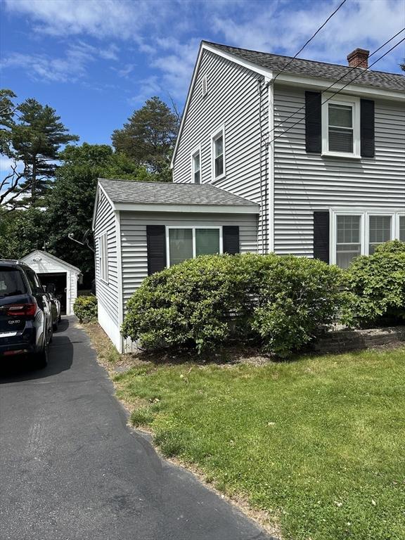 10 Marilyn Dr, Auburn, MA 01501 - view of home's exterior featuring a lawn, a detached garage, a chimney, and roof with shingles