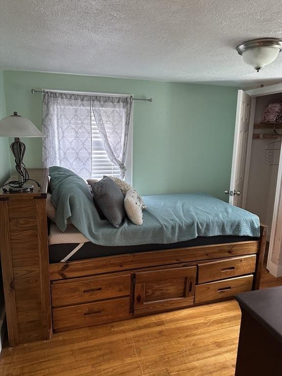 10 Marilyn Dr, Auburn, MA 01501 - bedroom with light wood-type flooring and a textured ceiling