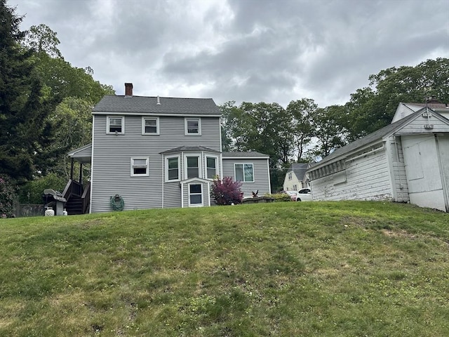 10 Marilyn Dr, Auburn, MA 01501 - back of house with a chimney and a yard