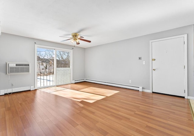 empty room with ceiling fan, an AC wall unit, a baseboard heating unit, and light hardwood / wood-style floors