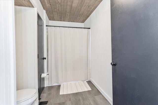 bathroom with toilet, tile patterned floors, and wooden ceiling