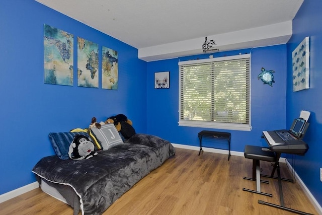 living area featuring baseboards and wood finished floors