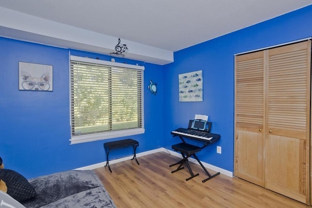 sitting room featuring light wood-type flooring and baseboards