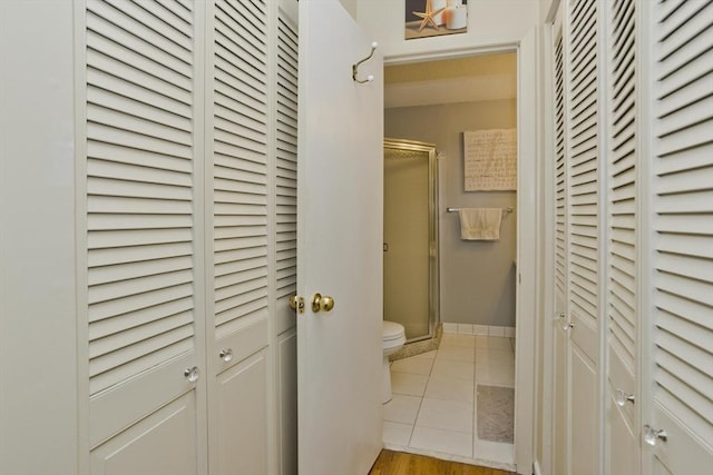 hallway featuring tile patterned flooring and baseboards