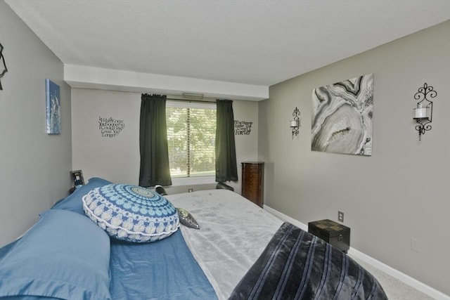 bedroom featuring carpet flooring and baseboards