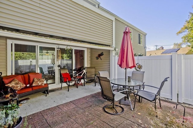 view of patio featuring fence and outdoor dining area