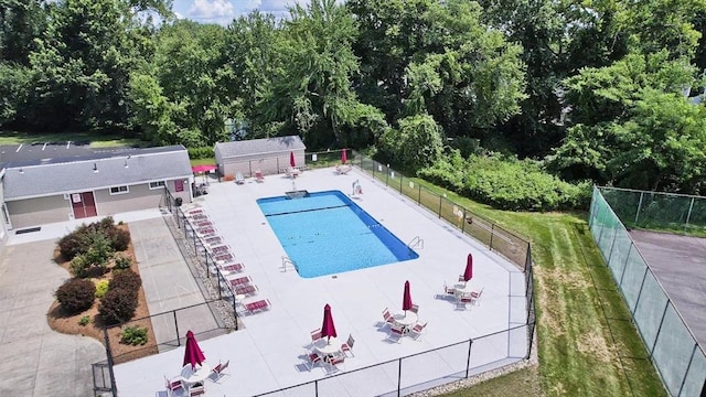 community pool featuring a patio area and fence