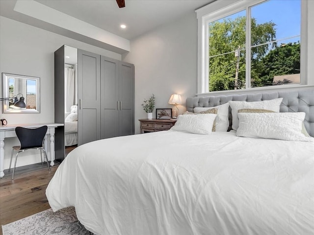 bedroom with dark wood-type flooring, multiple windows, and recessed lighting