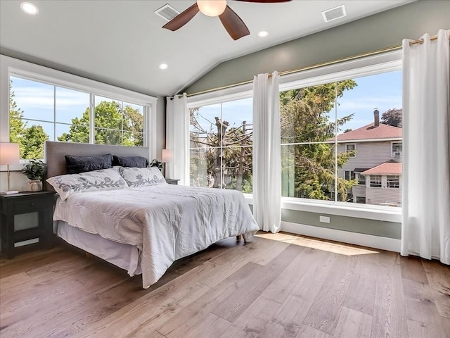 bedroom with light wood-type flooring, recessed lighting, visible vents, and lofted ceiling