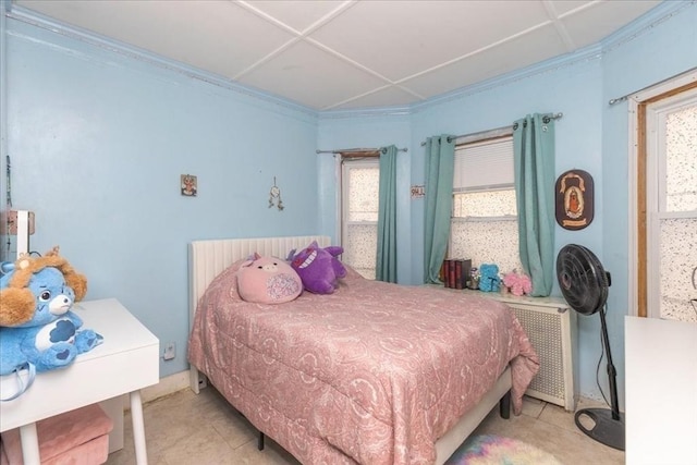 bedroom featuring radiator and ornamental molding