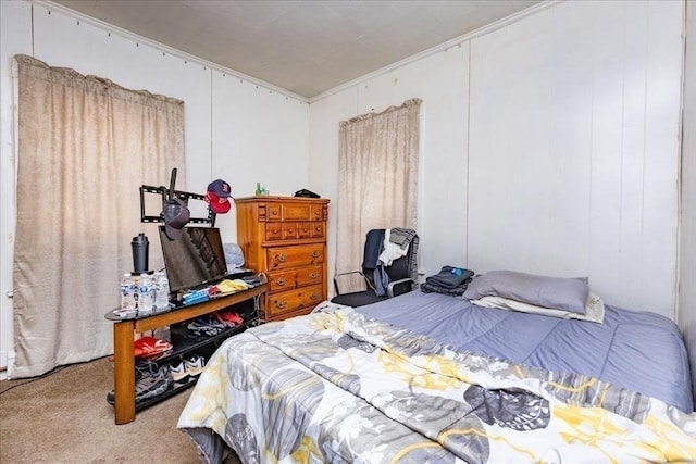 bedroom with carpet and a decorative wall