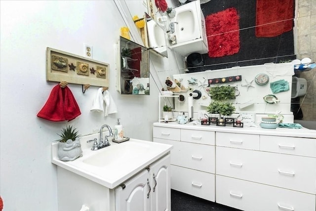 kitchen featuring light countertops, white cabinetry, and a sink