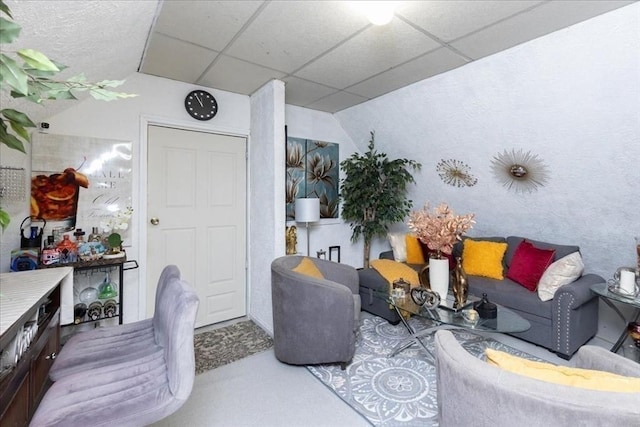 living area featuring a paneled ceiling