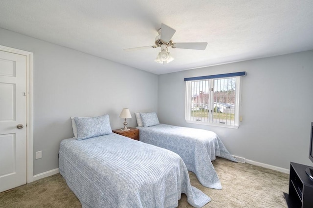 carpeted bedroom with baseboards and ceiling fan
