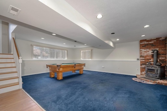 rec room with a wood stove, carpet, pool table, baseboards, and visible vents