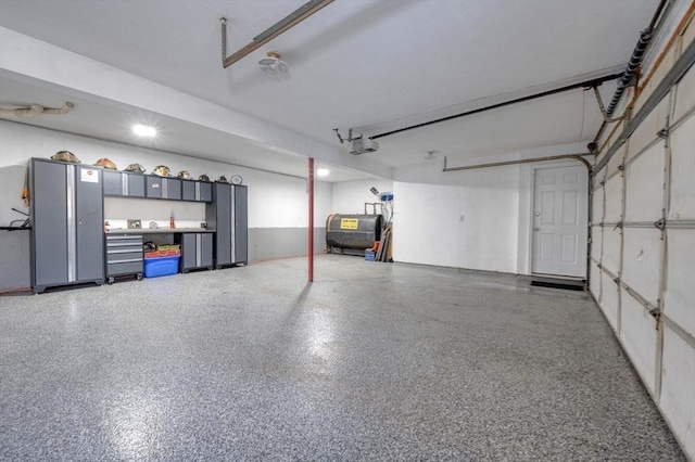 garage featuring a garage door opener and heating fuel